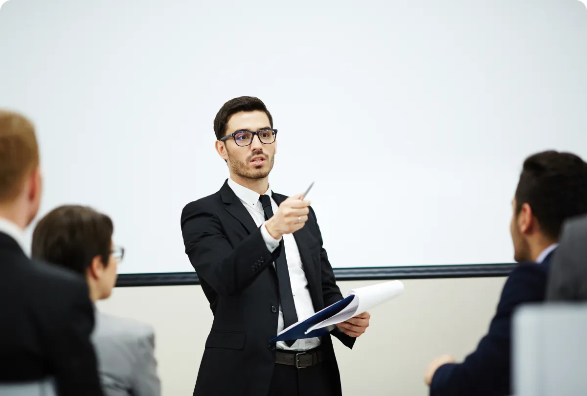 Faculty member listening to an engineer during an industrial visit